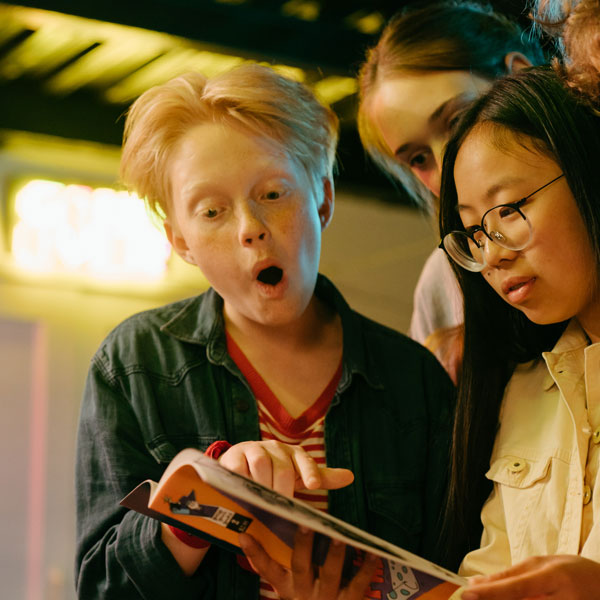 Young performers exploring a dramatic text together